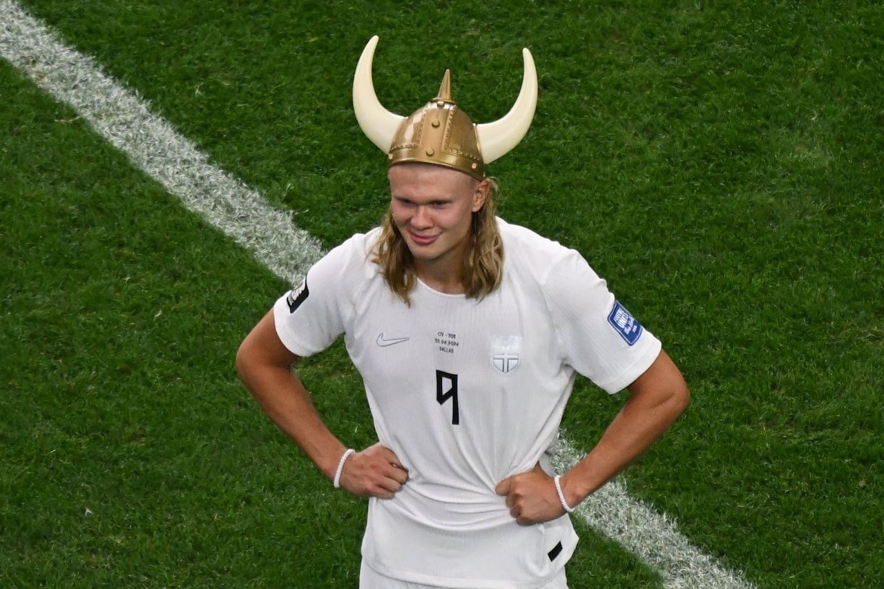 default-1084 A man in a soccer jersey wearing a viking hat