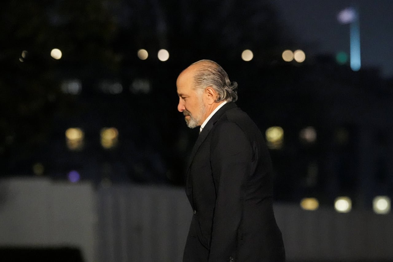 A man in a suit at night.