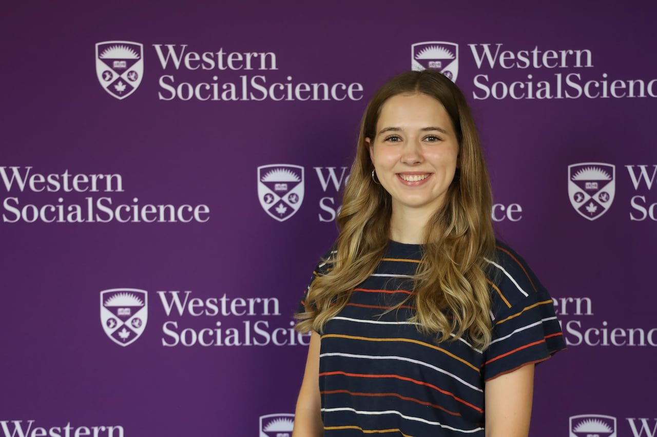 default-967 student stands in front of a western decal wall